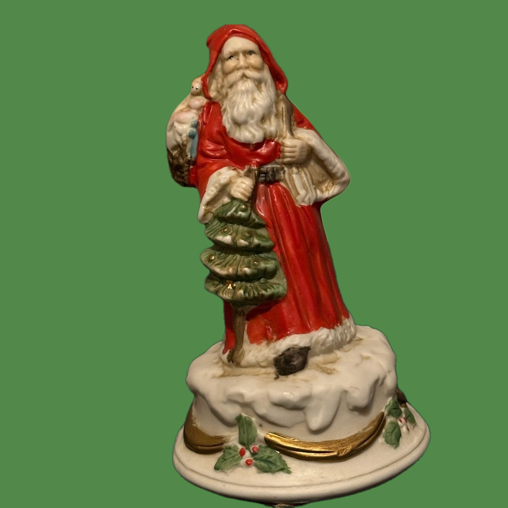 Revolving porcelain Santa musical figure plays Santa Claus is Coming to Town.